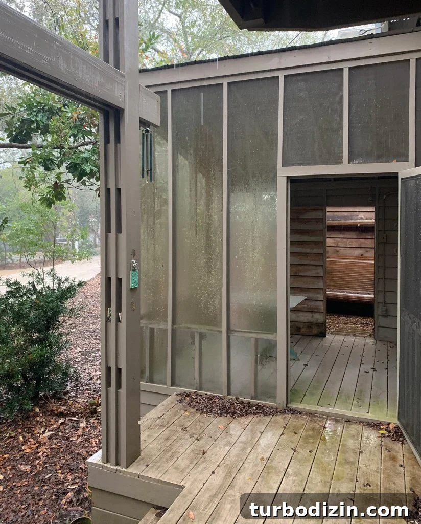 How to Hang an Outdoor Daybed: Step-by-Step Video Guide 13 Before photo of same angle with brown railings and siding and gross screening