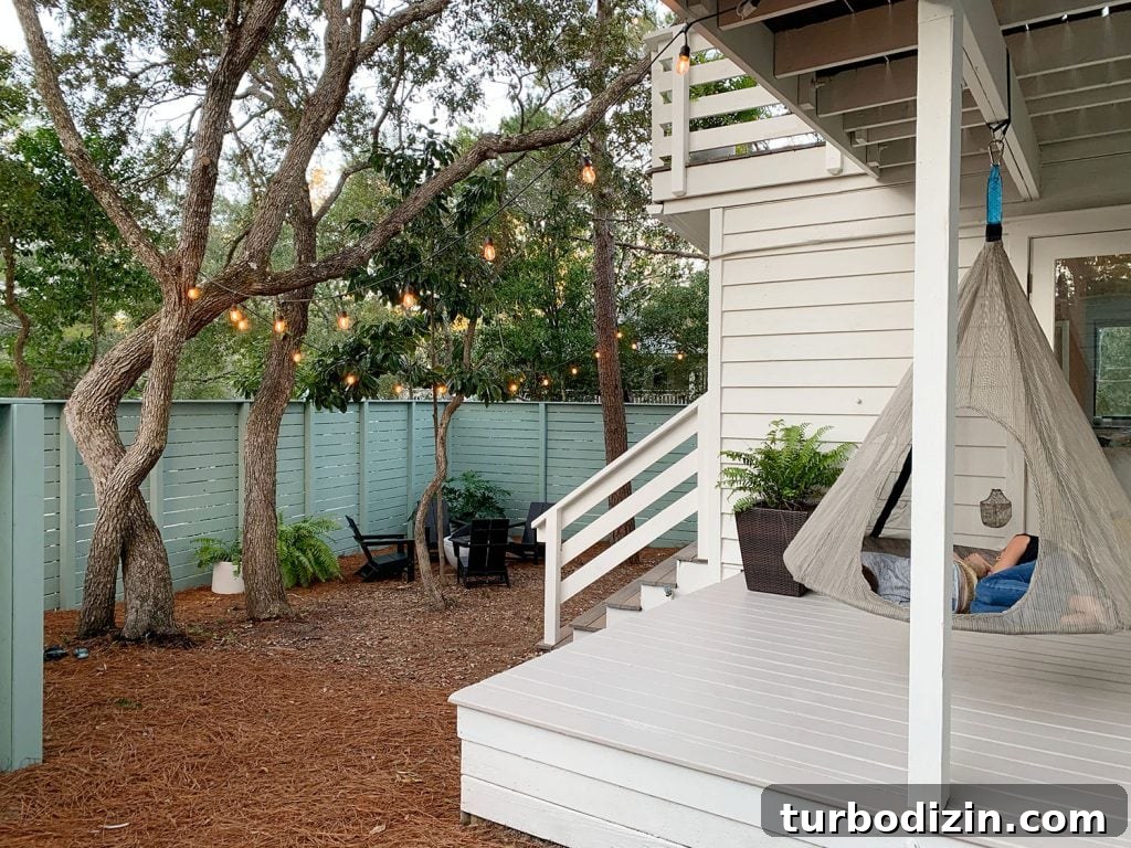 View of side yard and covered side porch with hanging tent swing