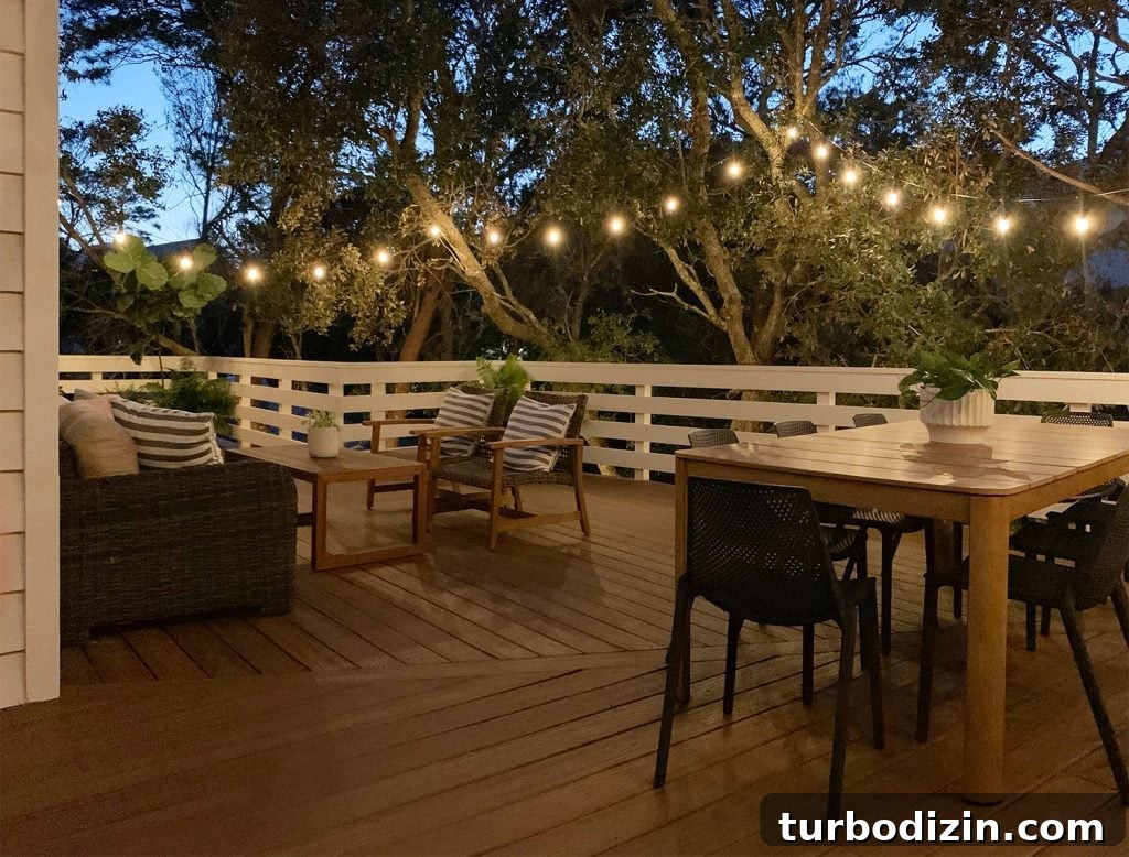 Before and After Home Photos: 14 Months of Renovation Progress 20 Nighttime View Of Large Deck With String Lights