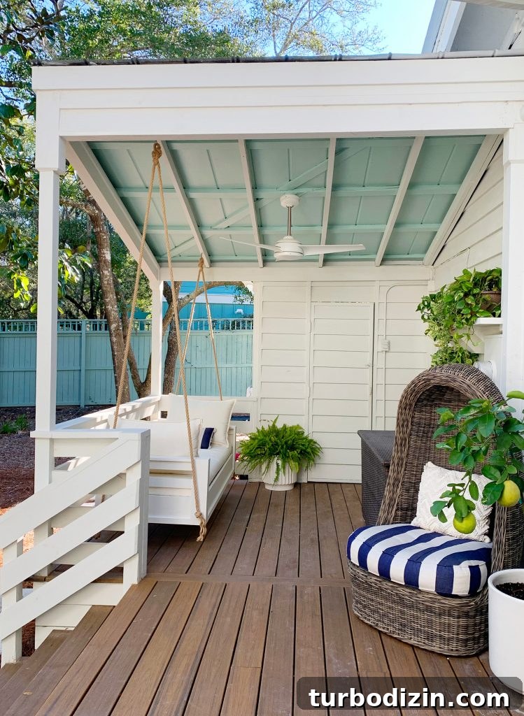 Before and After Home Photos: 14 Months of Renovation Progress 42 Finished White Hanging Daybed Under Covered Front Porch