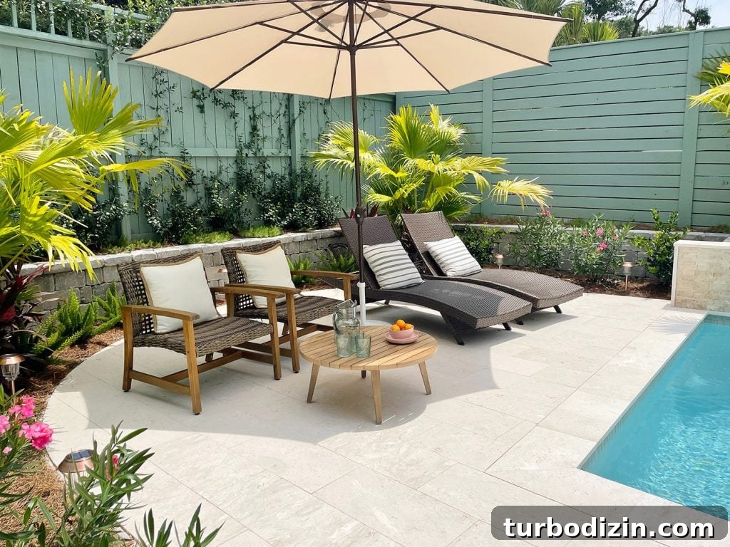Round pool patio area surrounded by tropical plantings Chinese palms oleander jasmine stonecrop foxtail ferns