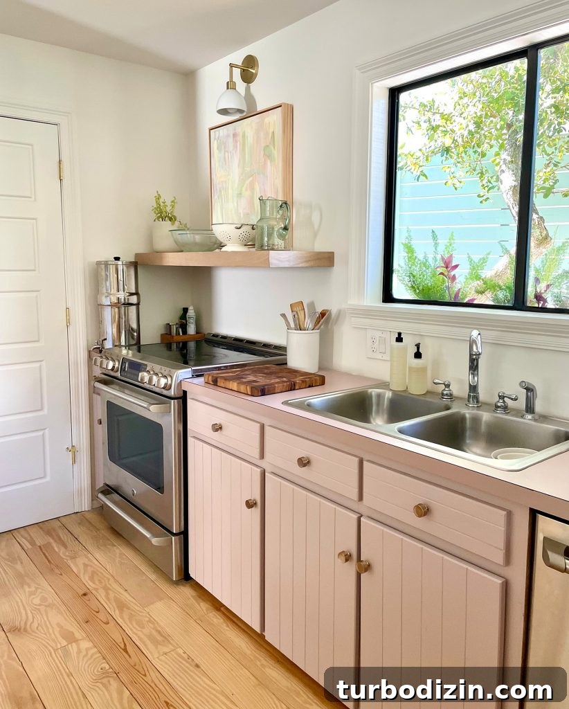 9 Smart Small Kitchen Ideas to Maximize Space and Style 7 Beachy Kitchen With Mauve Pink Cabinets And Wood Floating Shelves With Mid Century Modern Lights