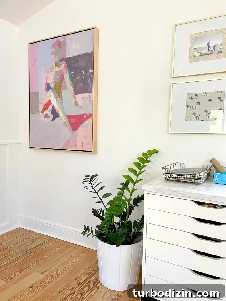 Family Room That Doubles as Office, Art Studio, and Home Theater 17 Painting Artwork Hung By Upstairs Family Room Kids Art Desk With ZZ Plant