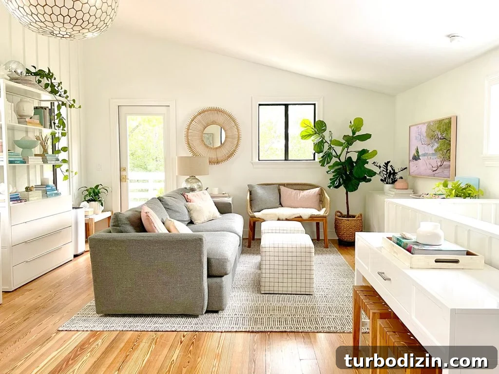 Family Room That Doubles as Office, Art Studio, and Home Theater 3 Wide View Of Upstairs Family Room With White Walls And Vaulted Ceiling With Plants