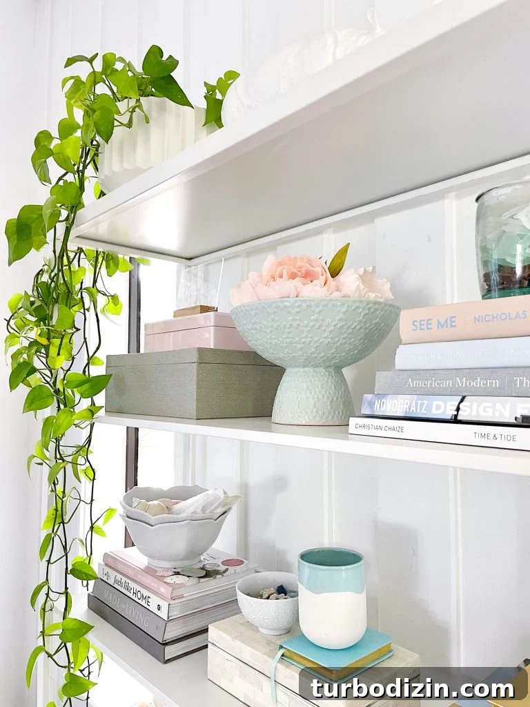 Family Room That Doubles as Office, Art Studio, and Home Theater 22 Side View Of Styled Shelves Of Ikea Fjalkinge Bookcase With Stacked Books And Plants