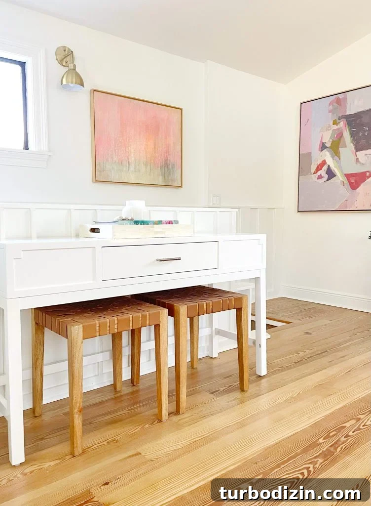 Family Room That Doubles as Office, Art Studio, and Home Theater 26 Console Table In Upstairs Modern Family Room With Leather Benches And Framed Painting Artwork In Background