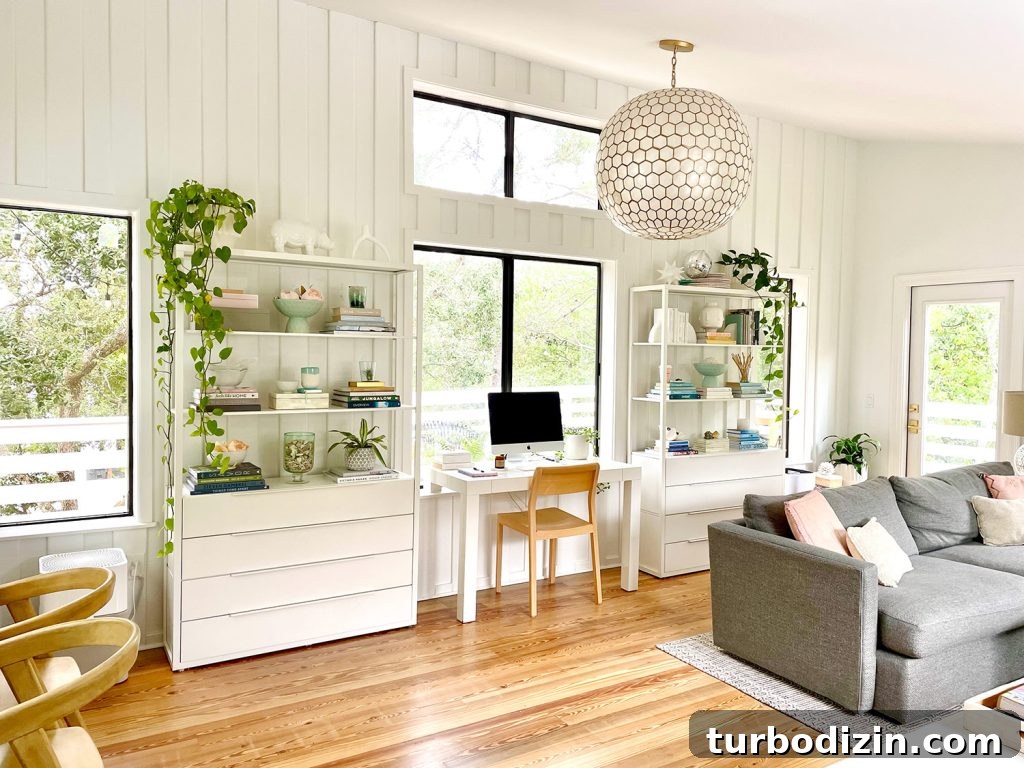 Family Room That Doubles as Office, Art Studio, and Home Theater 10 After Photo Of Modern Upstairs Family Room With White Paneled Walls And Capiz Globe Light Fixture