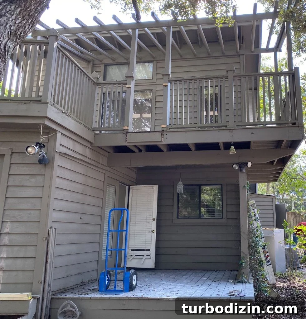 Transforming Our Kitchen Porch into a Cozy Dining Nook 3 Before photo of brown painted house with dirty side yard