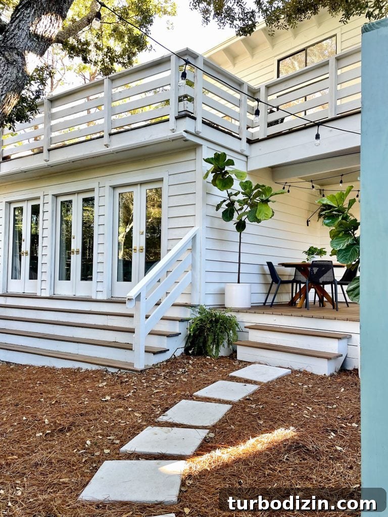 Transforming Our Kitchen Porch into a Cozy Dining Nook 16 Angled view through fence gate at side porch yard area with doors to bedroom