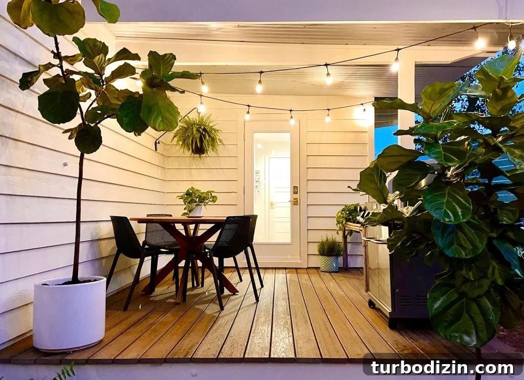 Transforming Our Kitchen Porch into a Cozy Dining Nook 22 Viewing of dining table on covered kitchen porch under the glow of string lights
