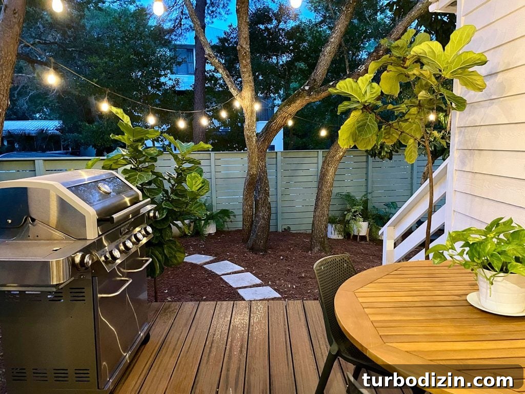 Transforming Our Kitchen Porch into a Cozy Dining Nook 23 View looking out from kitchen porch with string lights glowing above grill and table for eating