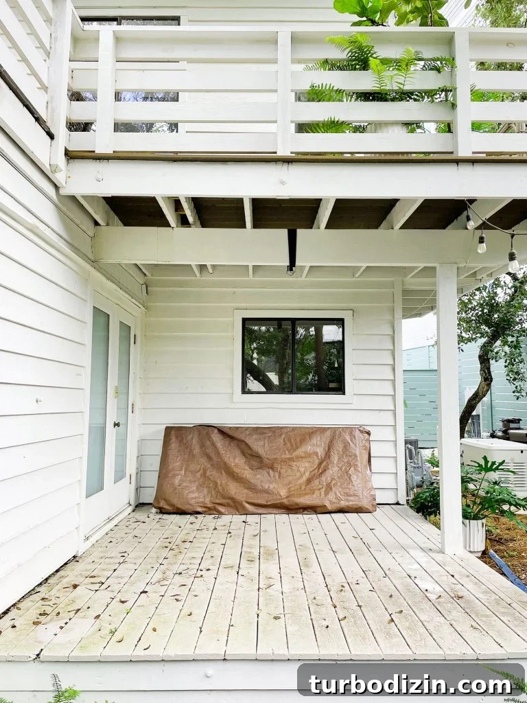 Transforming Our Kitchen Porch into a Cozy Dining Nook 5 Midpoint photo of cover porch with stained painted floor and no furniture