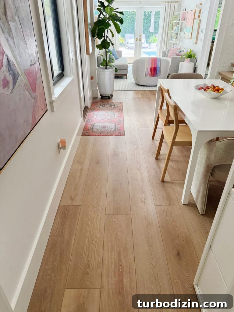 New Flooring FAQ: Answers About Installation, Care and Warranty 10 New LVP Floors Running Through Kitchen In Downstairs Renovation